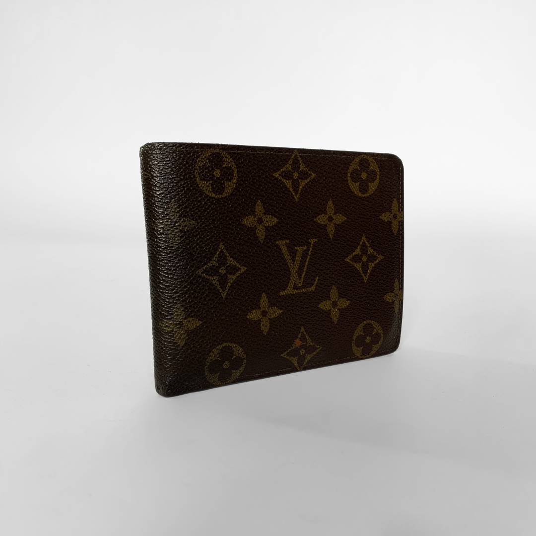 A Louis Vuitton monogram wallet in dark brown coated canvas with tan/gold printed LV logos and floral motifs, shown standing upright on a light gray gradient background.