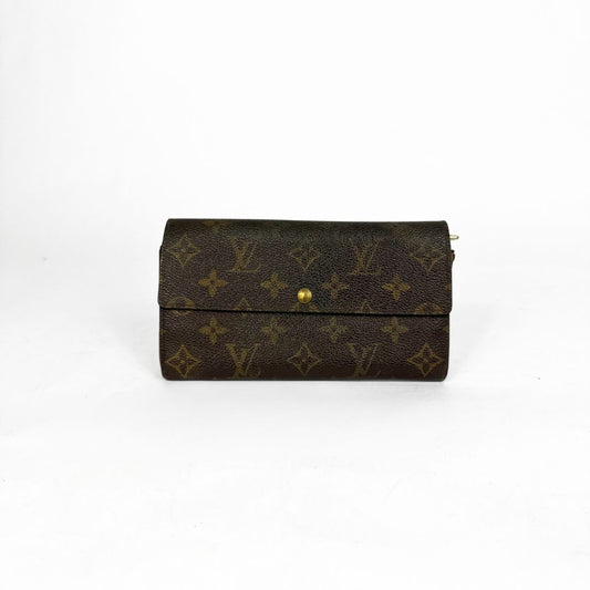 Louis Vuitton wallet with monogram pattern on a white background