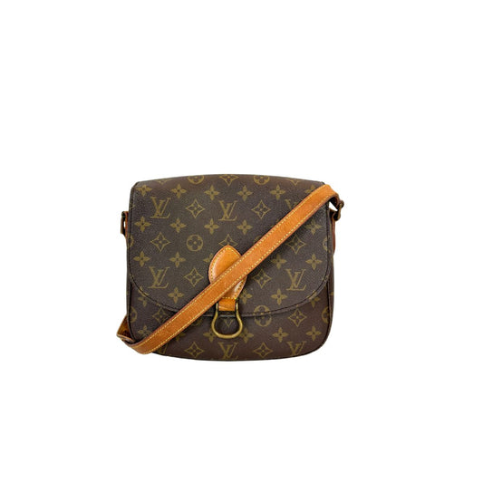 Brown monogram handbag with tan strap on a white background