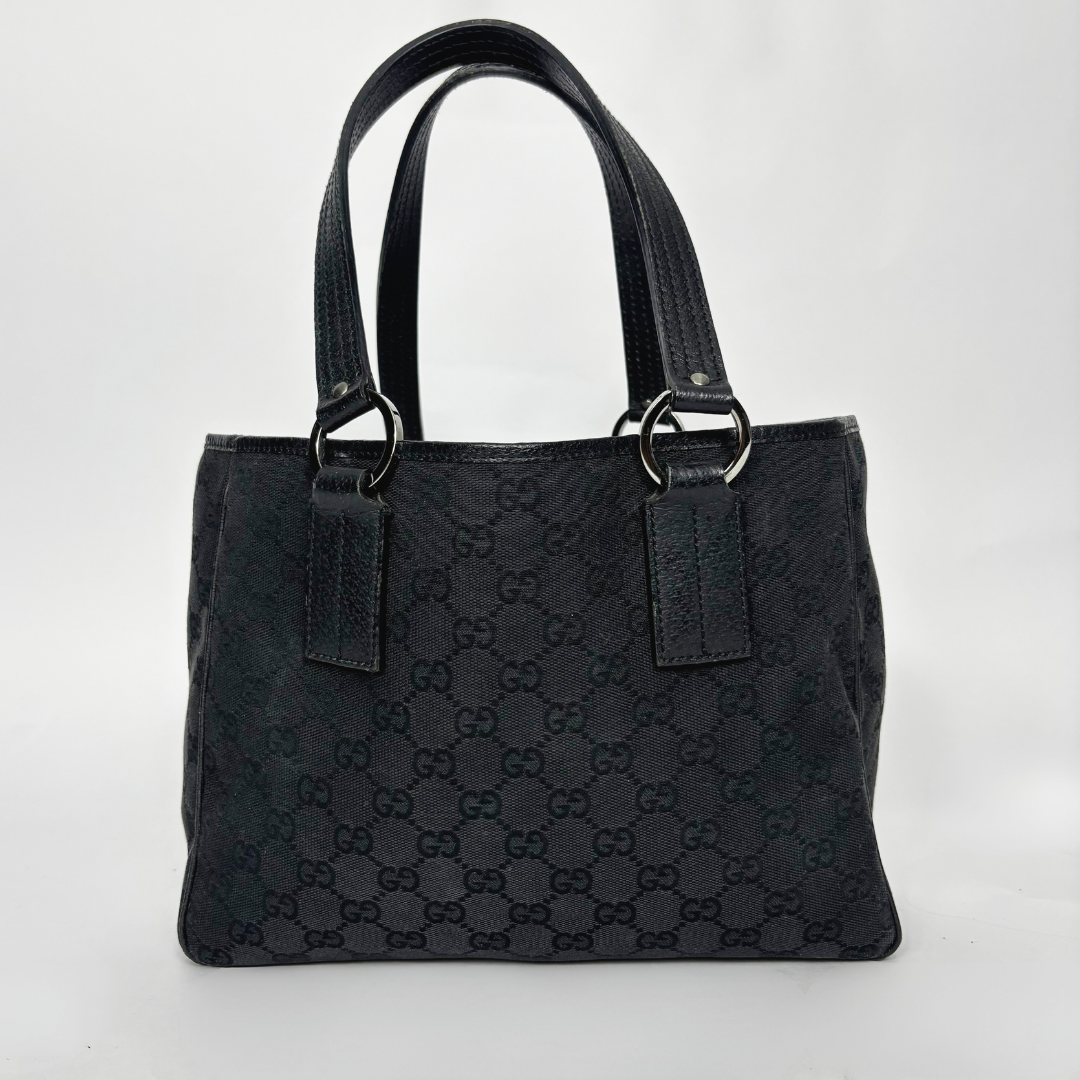 Black textured handbag with brand logo on a white background