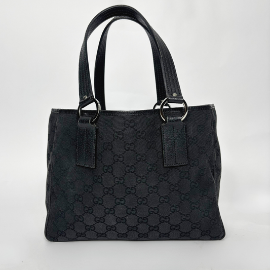 Black textured handbag with brand logo on a white background