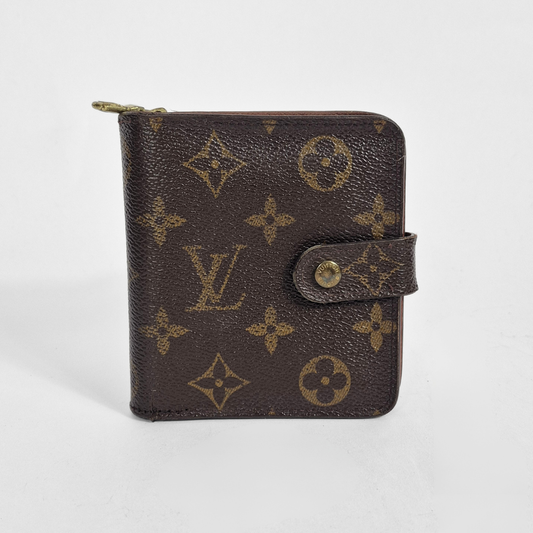 Louis Vuitton wallet with monogram pattern on a white background
