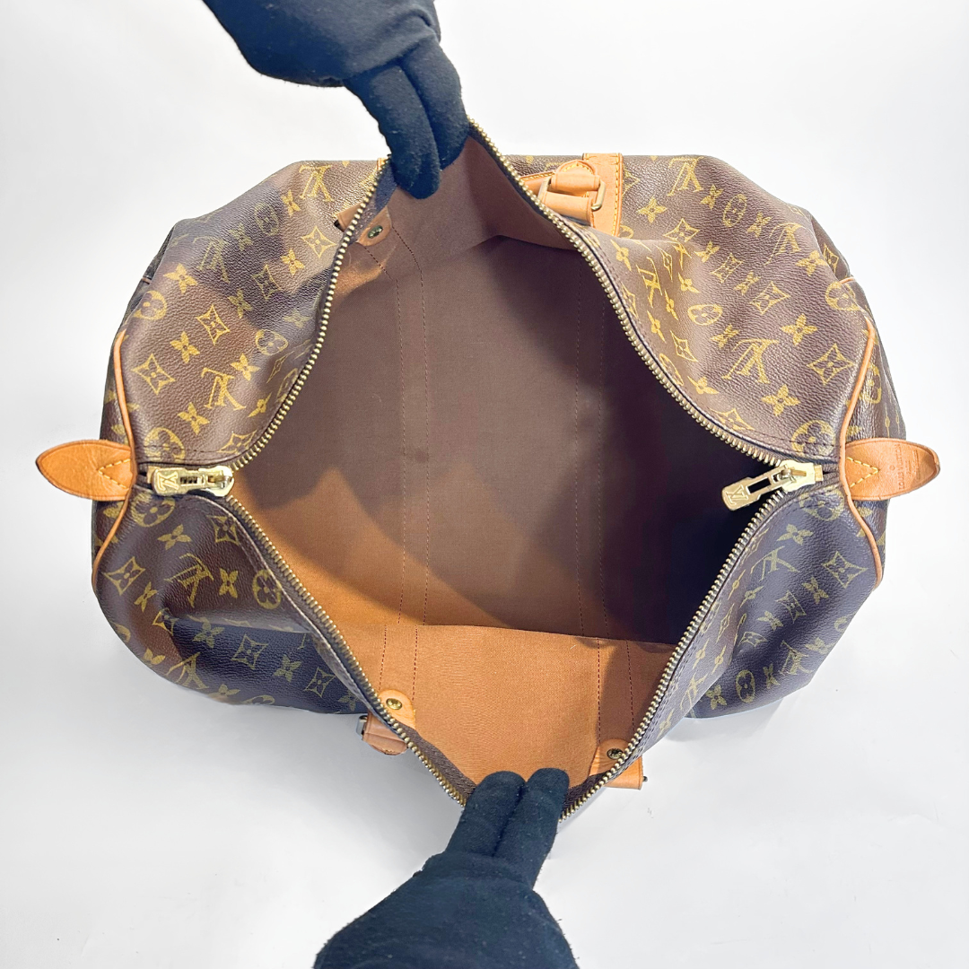 Louis Vuitton monogram handbag with open top on a white background