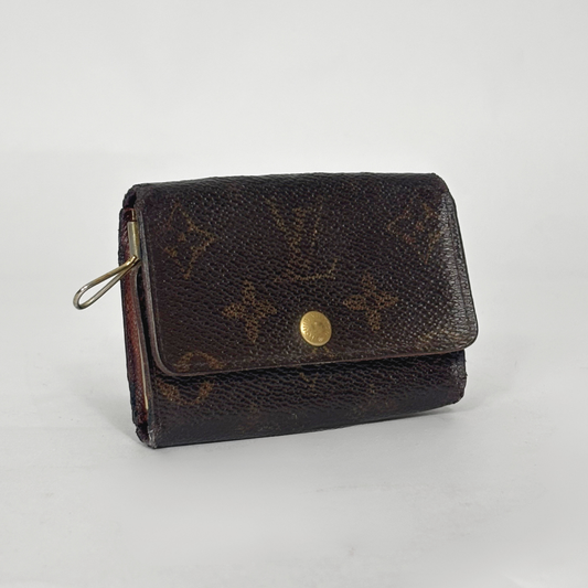Brown wallet with gold accents on a light gray background