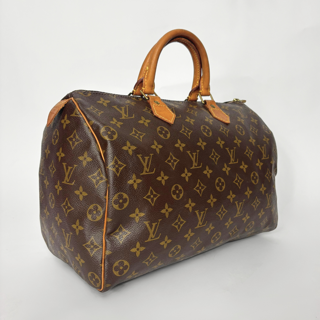 Brown handbag with monogram pattern on a white background