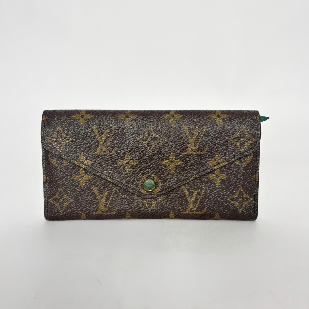 Designer wallet with monogram pattern on a white background