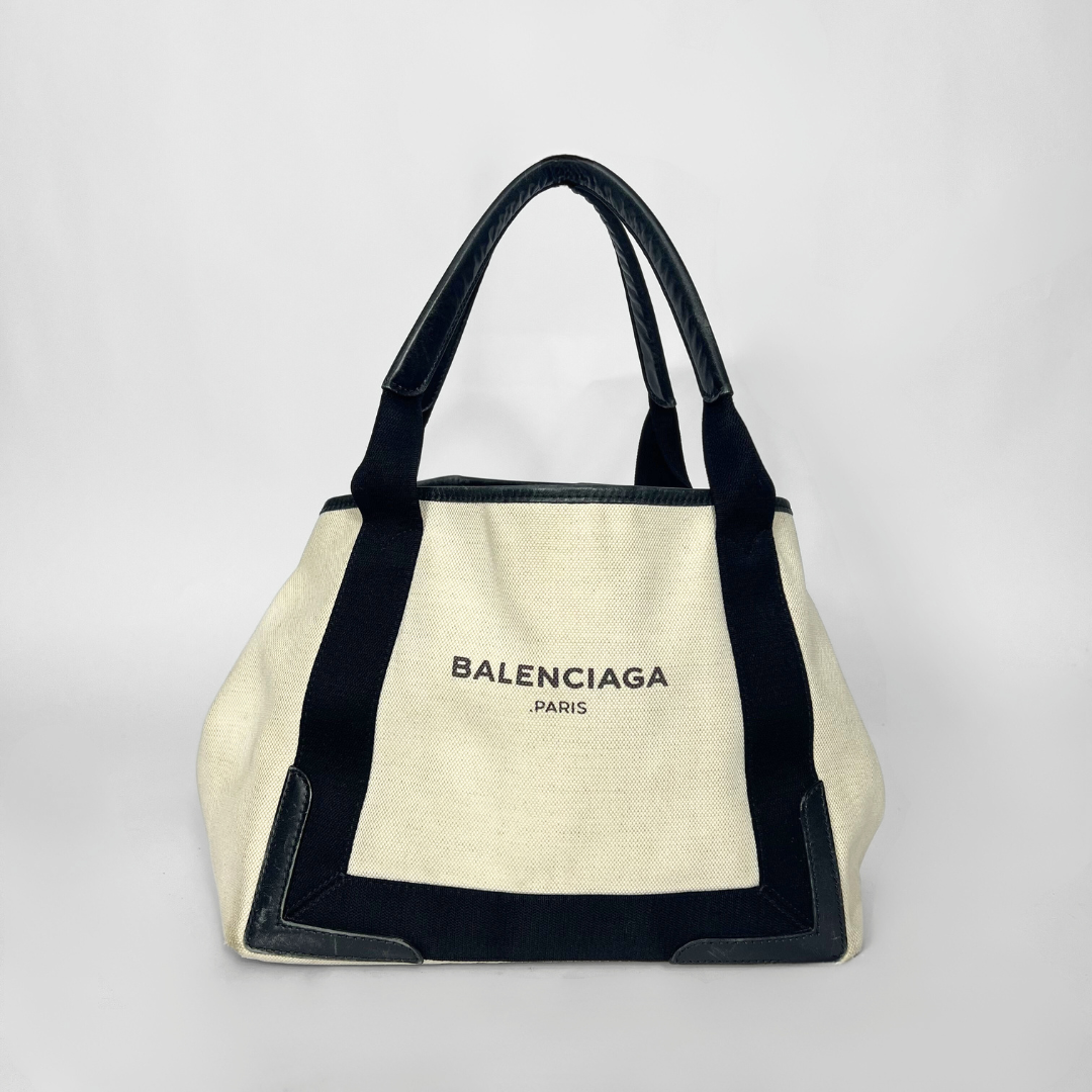 Balenciaga tote bag with black accents on a light gray background