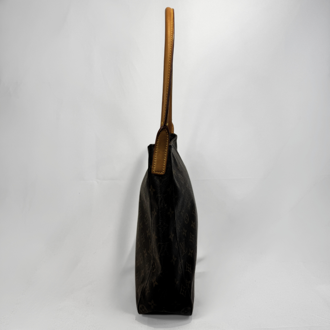 A dark brown Louis Vuitton monogram canvas tote bag with tan leather shoulder straps, shown from a side profile view against a white studio background.