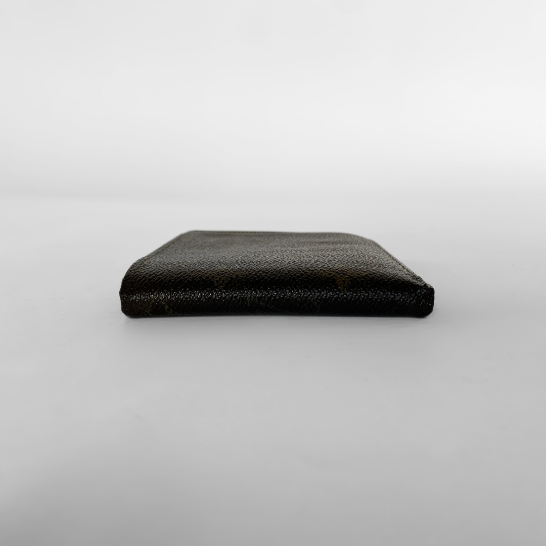 A Louis Vuitton monogram bifold wallet in dark brown coated canvas with the classic tan/gold LV monogram pattern, shown against a neutral light gray background.