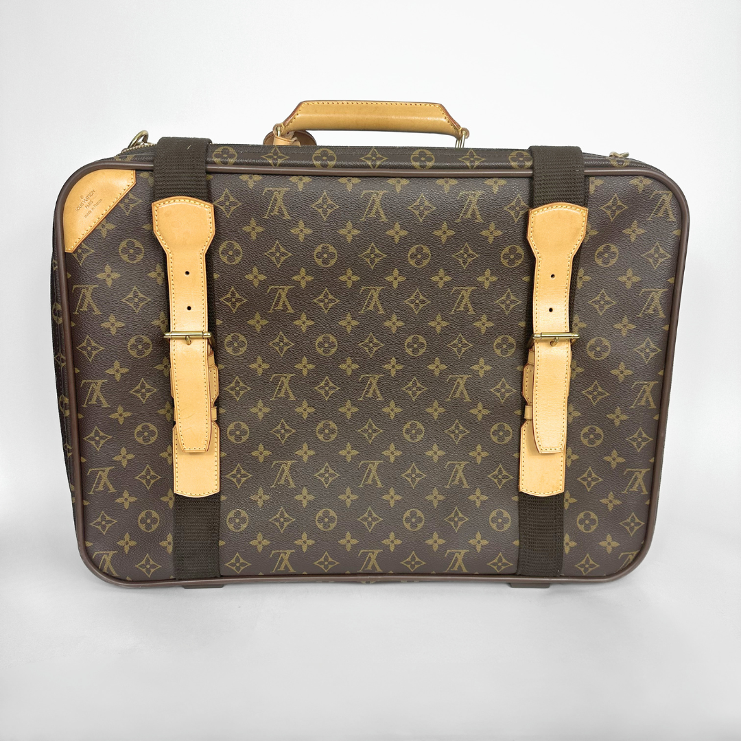 Brown suitcase with gold accents and monogram pattern on a white background