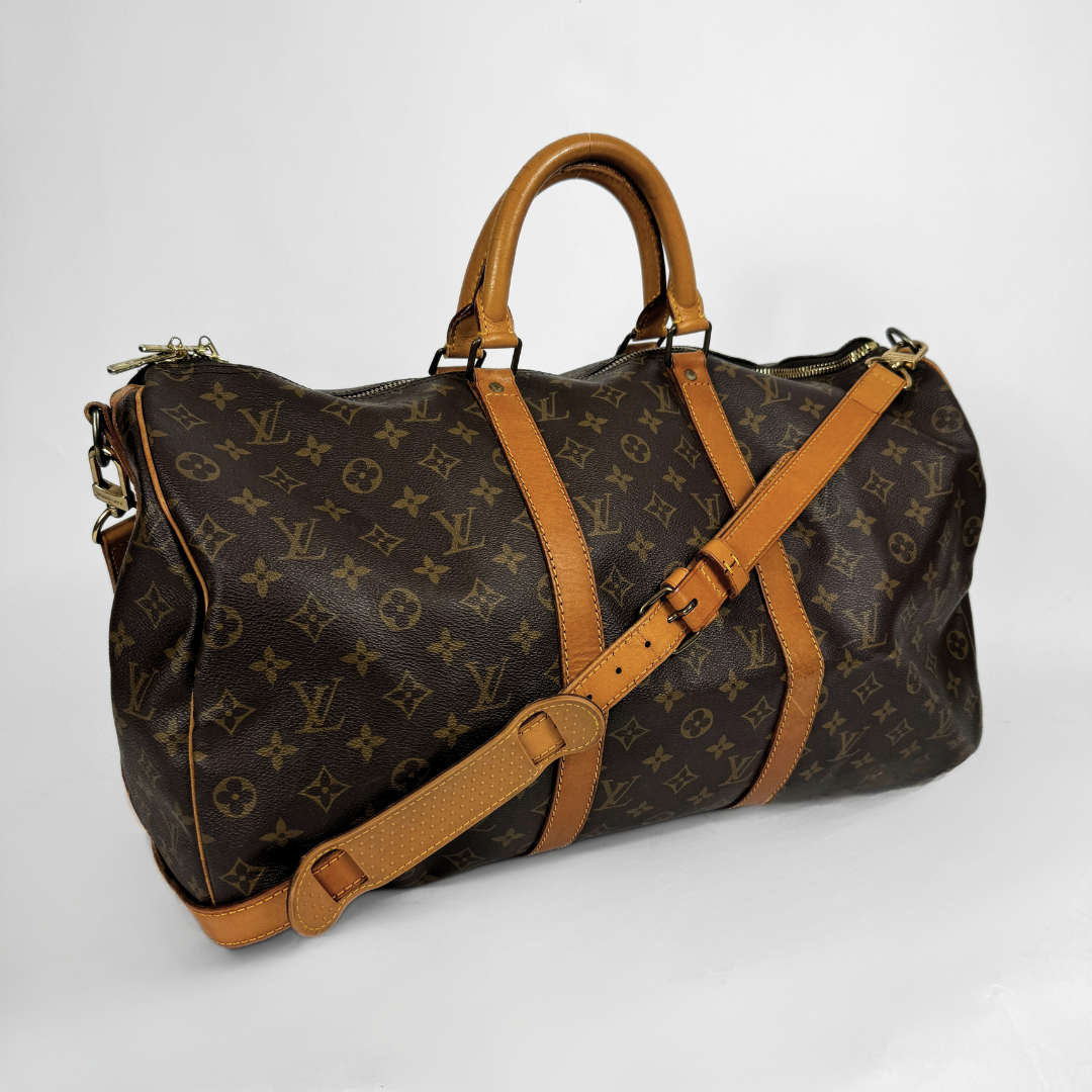 Louis Vuitton Keepall 50 with strap on a white background 