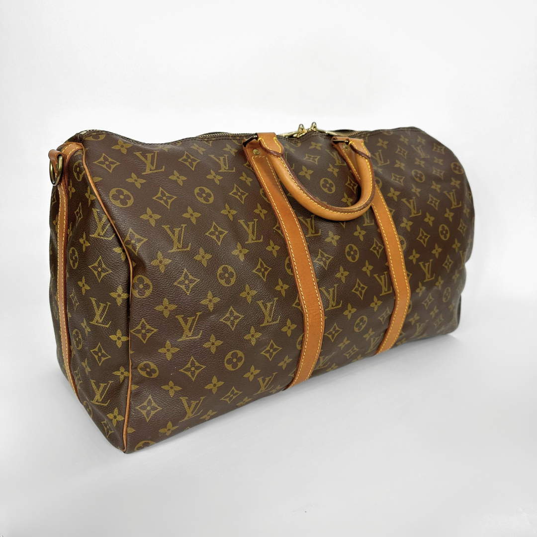 Brown patterned handbag with tan accents on a white background