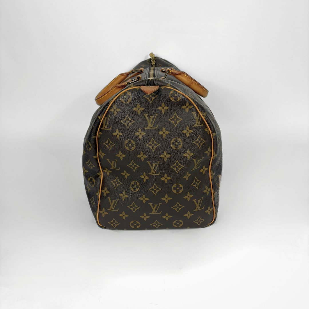Designer handbag with monogram pattern on a white background