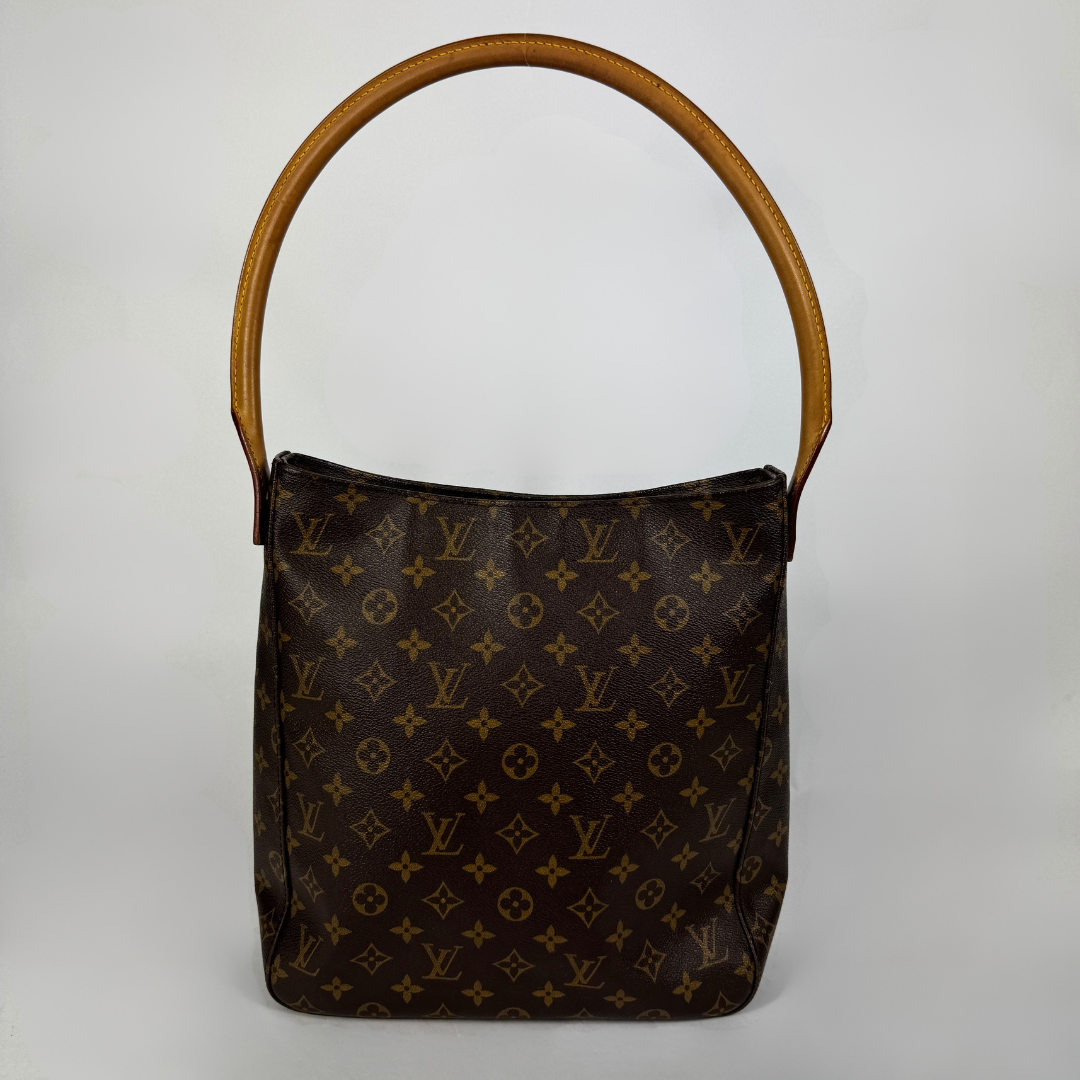 A Louis Vuitton monogram canvas shoulder bag with a brown leather handle, photographed against a neutral light gray background.