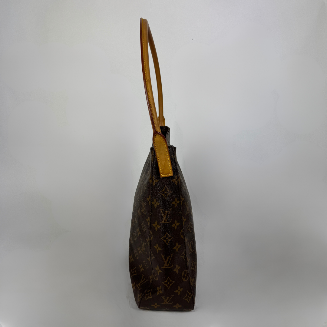 A Louis Vuitton monogram canvas shoulder bag shown from a side profile view against a plain light gray background.