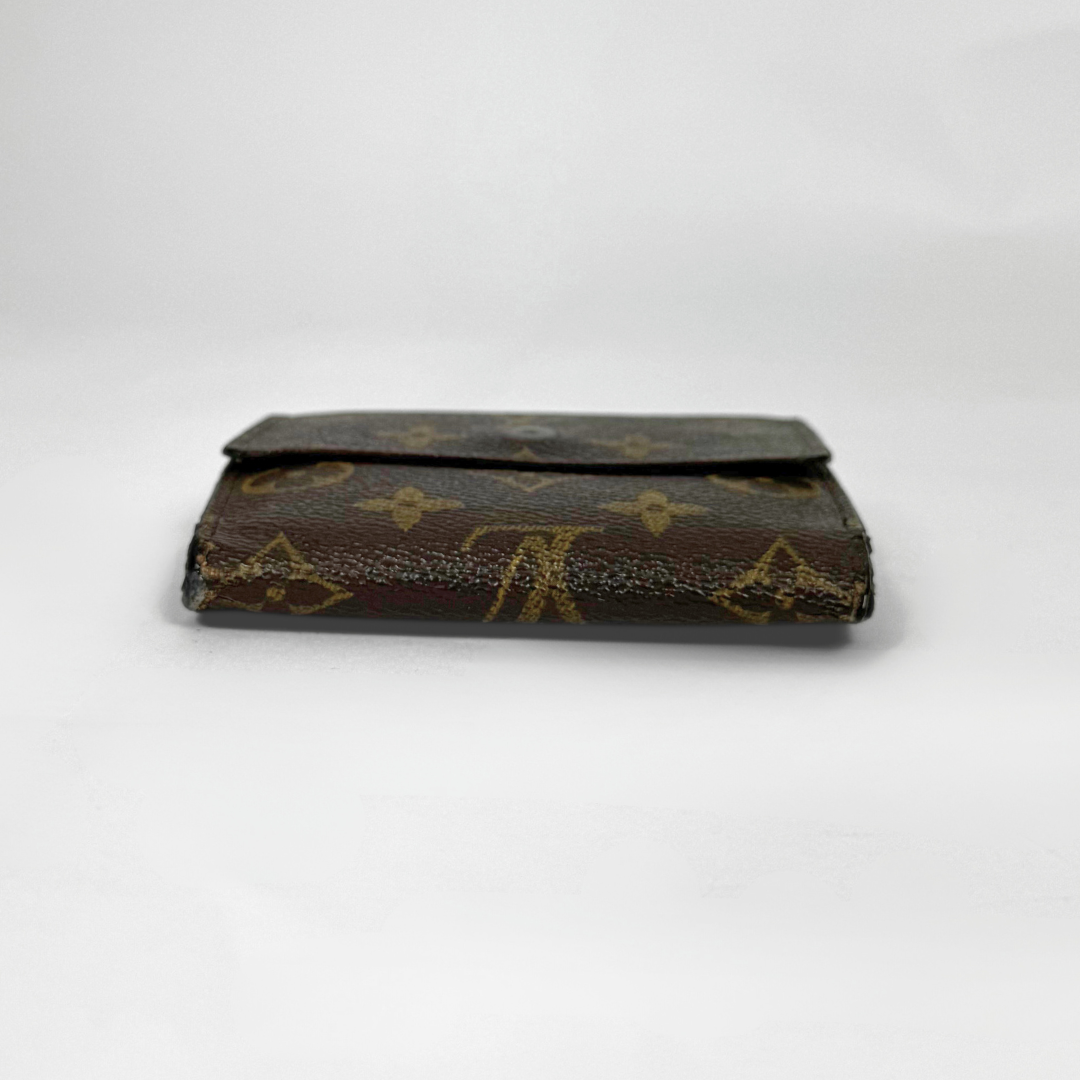 Vintage Louis Vuitton wallet with monogram pattern on a white background