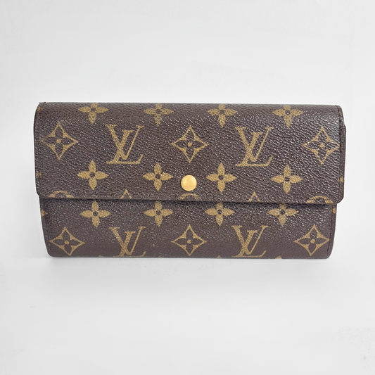 Louis Vuitton wallet with monogram pattern on a white background