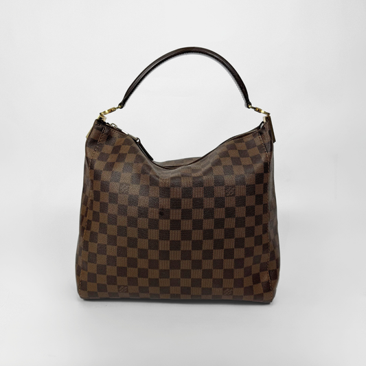 Brown checkered handbag with gold clasp on a white background

