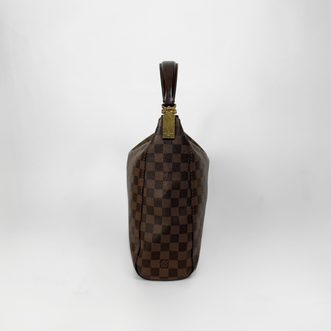 Brown checkered handbag with gold clasp on a white background