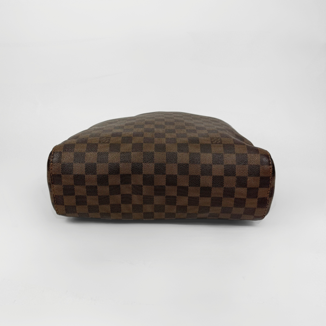 Brown checkered handbag with gold clasp on a white background