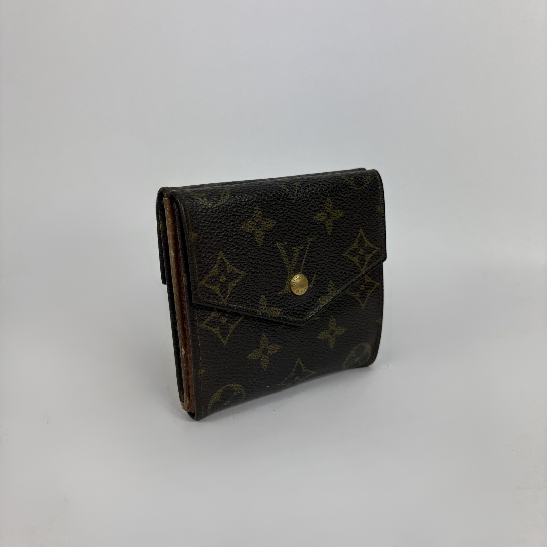A classic Louis Vuitton monogram bifold wallet in dark brown coated canvas with gold-tone hardware, photographed on a neutral light gray background.