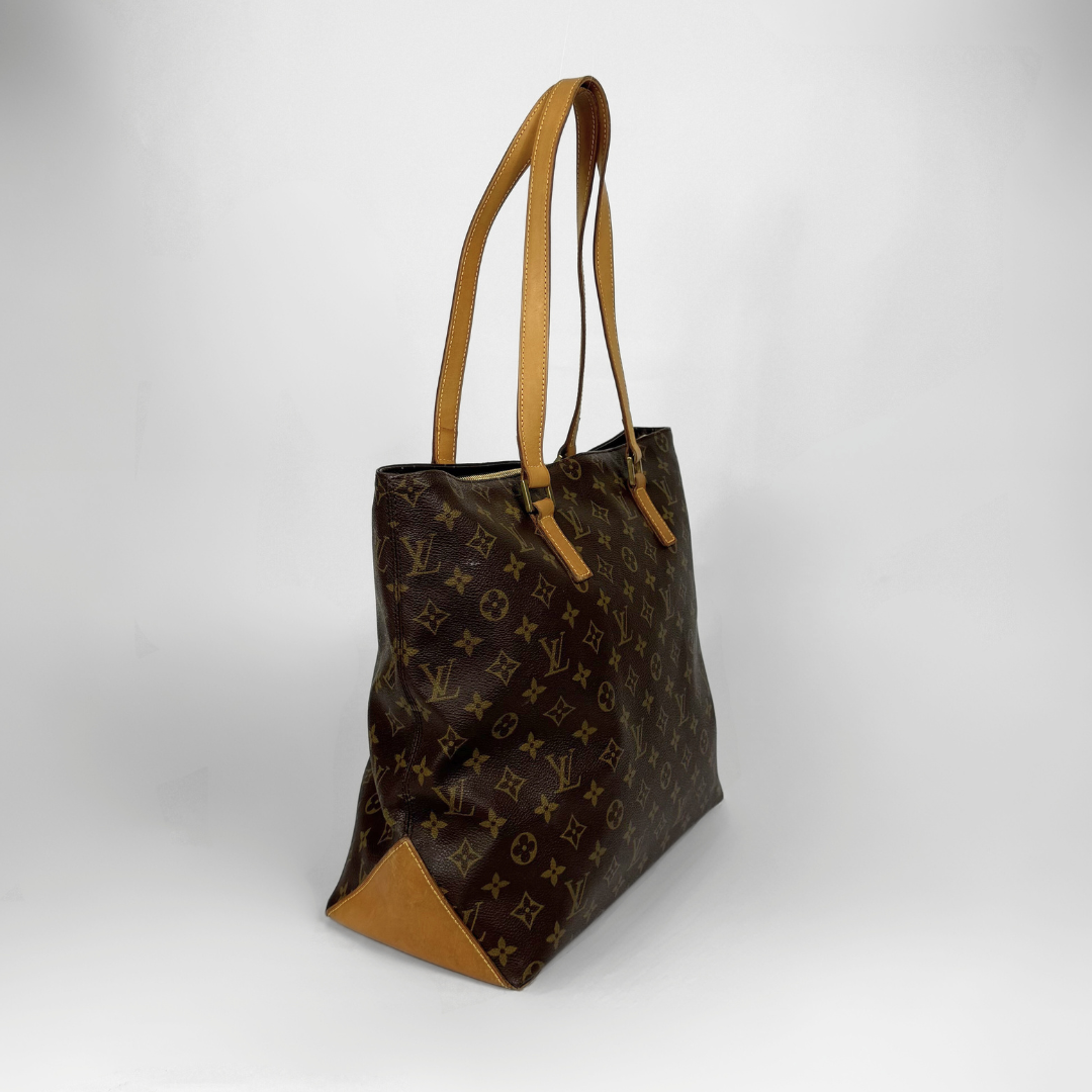 Designer handbag with monogram pattern on a white background