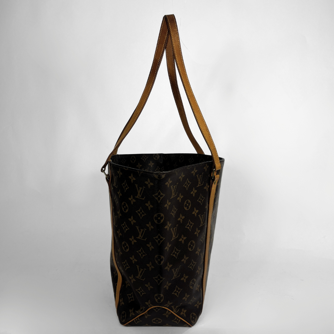 A Louis Vuitton monogram canvas tote bag with brown leather shoulder straps, shown against a plain light gray background.
