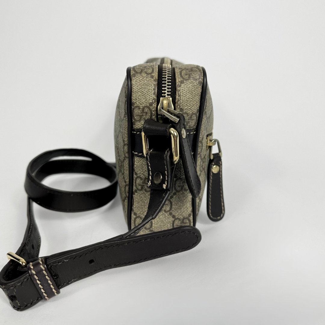 Gucci handbag with monogram pattern on a light gray background
