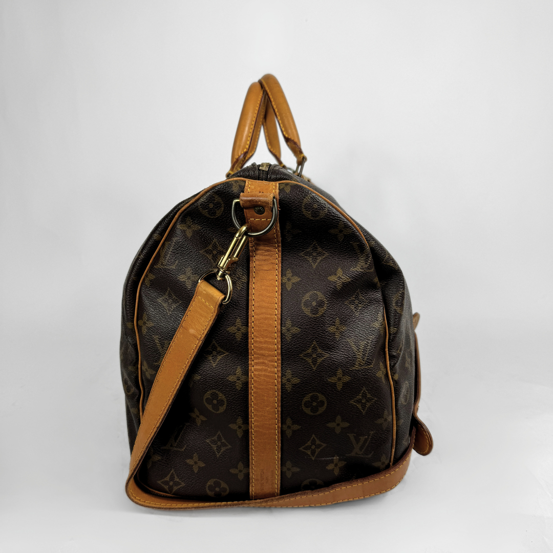 Louis Vuitton Keepall 50 with strap on a white background 