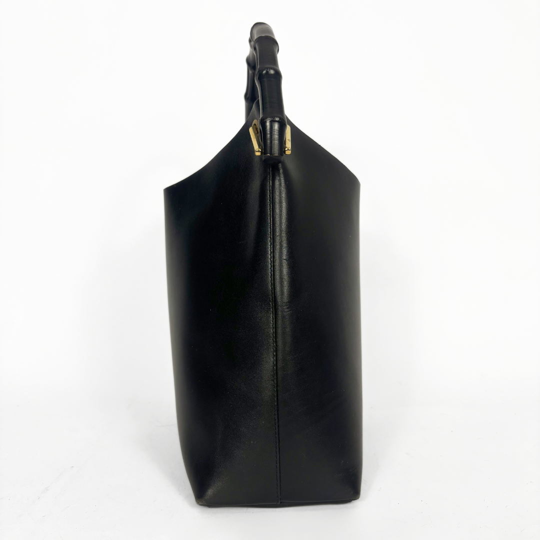 Gucci vintage black leather hobo hag with a dark wood bamboo top handle and gold-tone hardware.