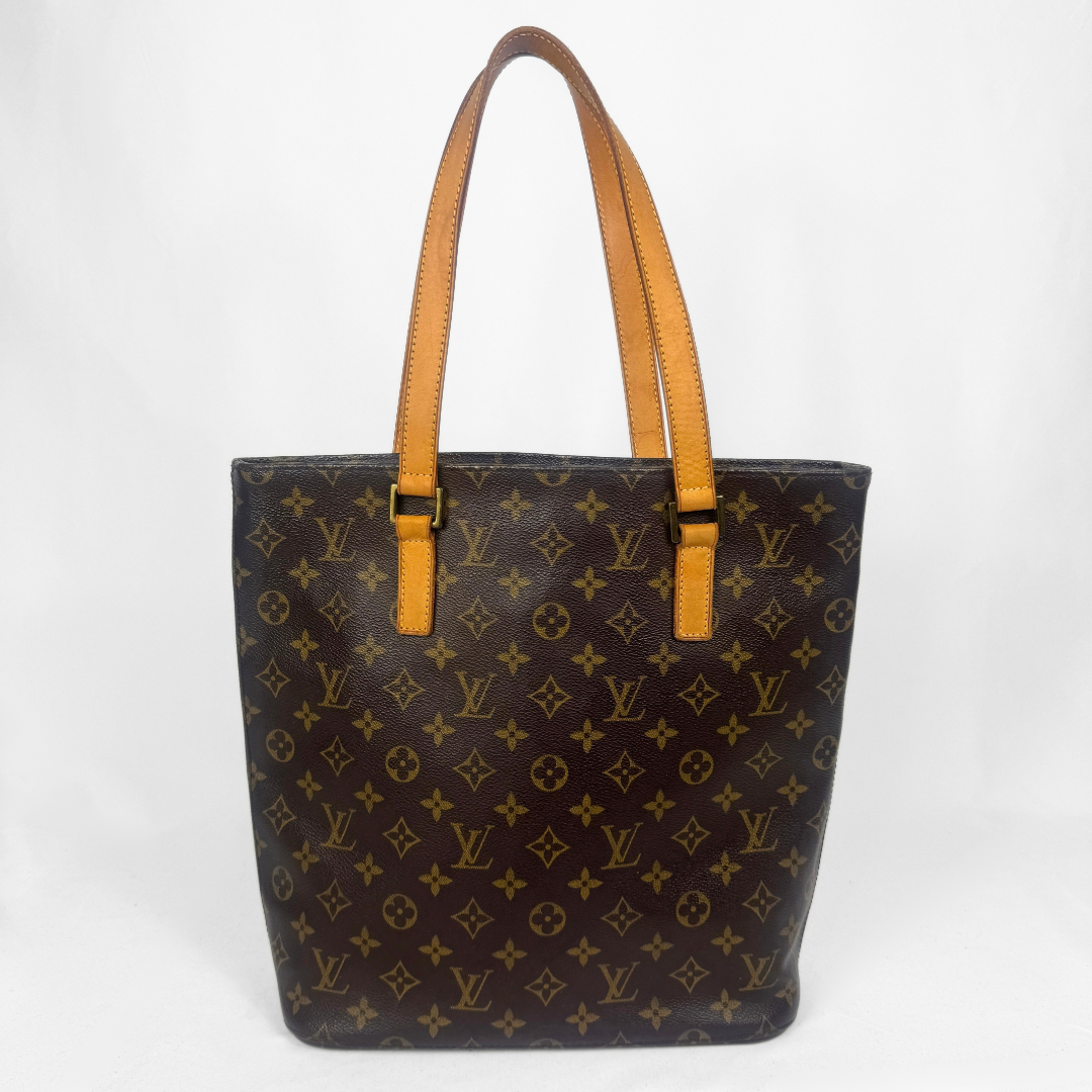 Louis Vuitton monogram canvas bag with tan leather shoulder straps, shown from the back against a white studio background.