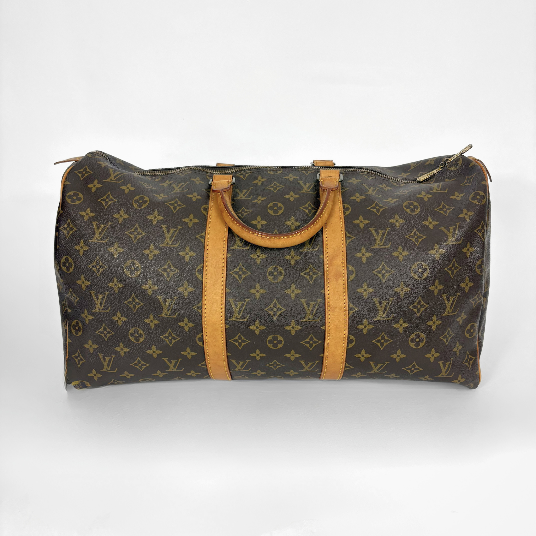 Louis Vuitton monogram travel bag with brown leather straps on a white background