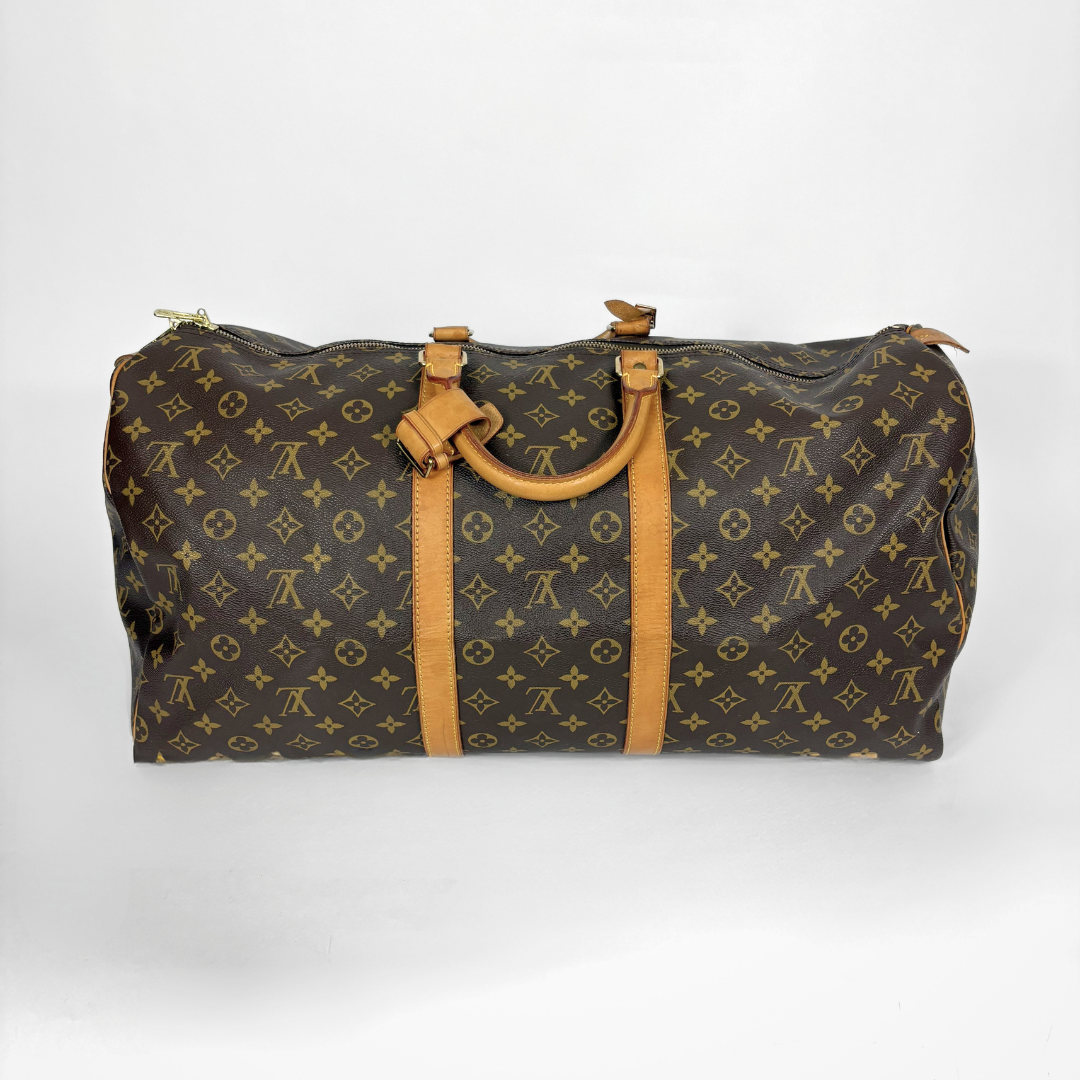 Brown duffel bag with tan leather handles and trim on a white background