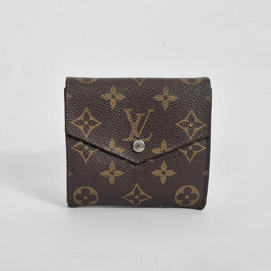 Brown wallet with gold monogram pattern on a white background