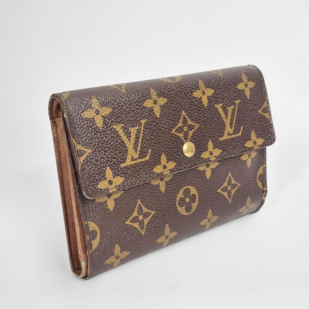 Louis Vuitton wallet with monogram pattern on a white background