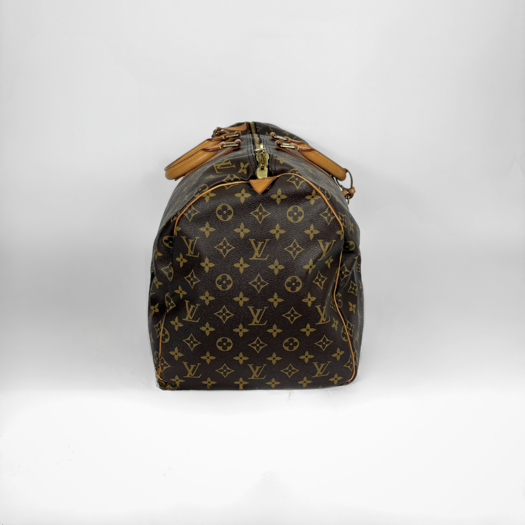 Designer handbag with monogram pattern on a white background