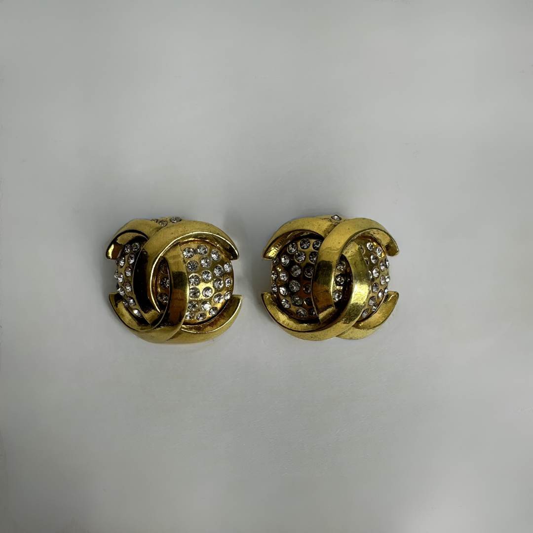 Chanel gold earrings on white background