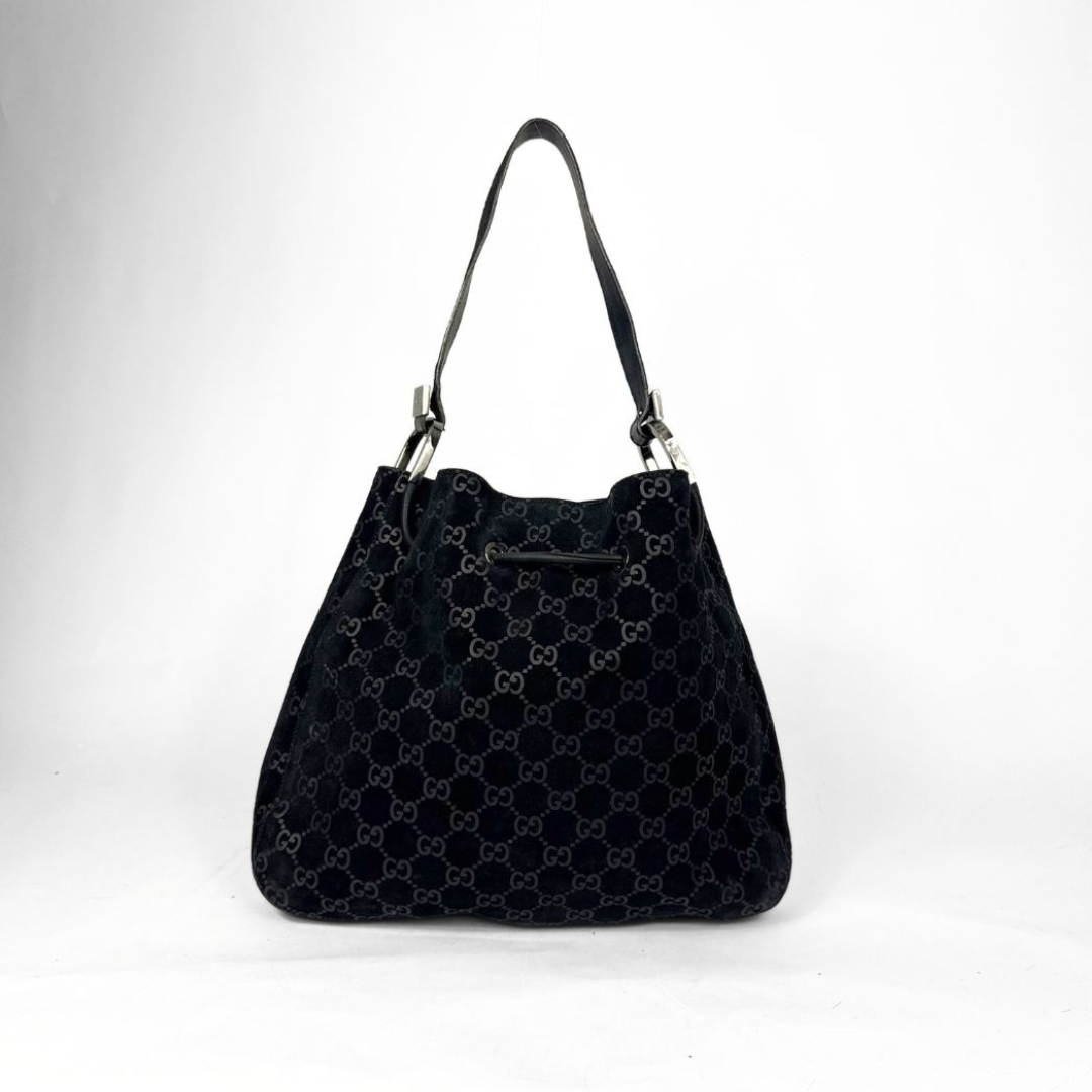 Gucci GG black suede shoulder bag on a white background