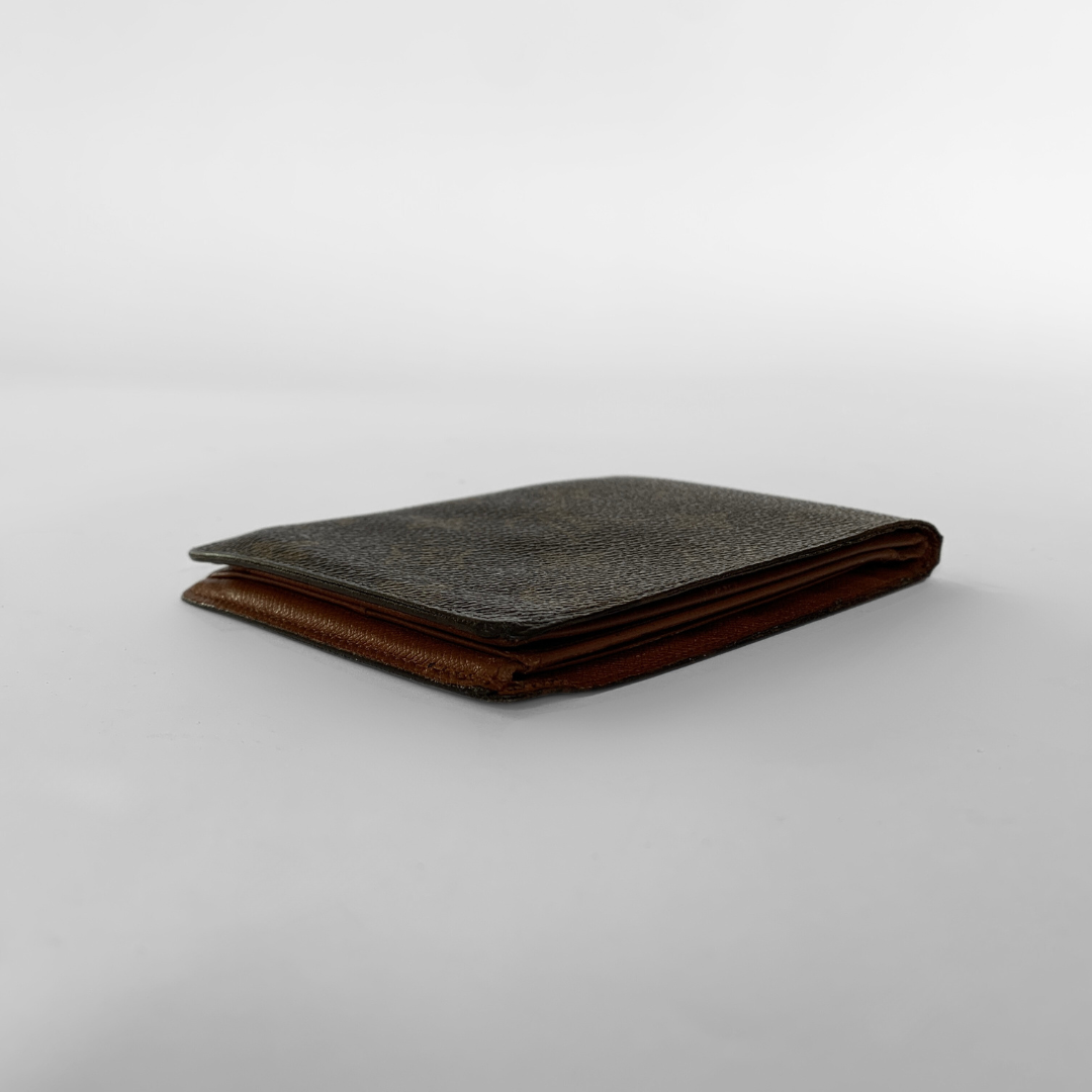 A Louis Vuitton monogram bifold wallet in dark brown coated canvas with the classic tan/gold LV monogram pattern, shown against a neutral light gray background.