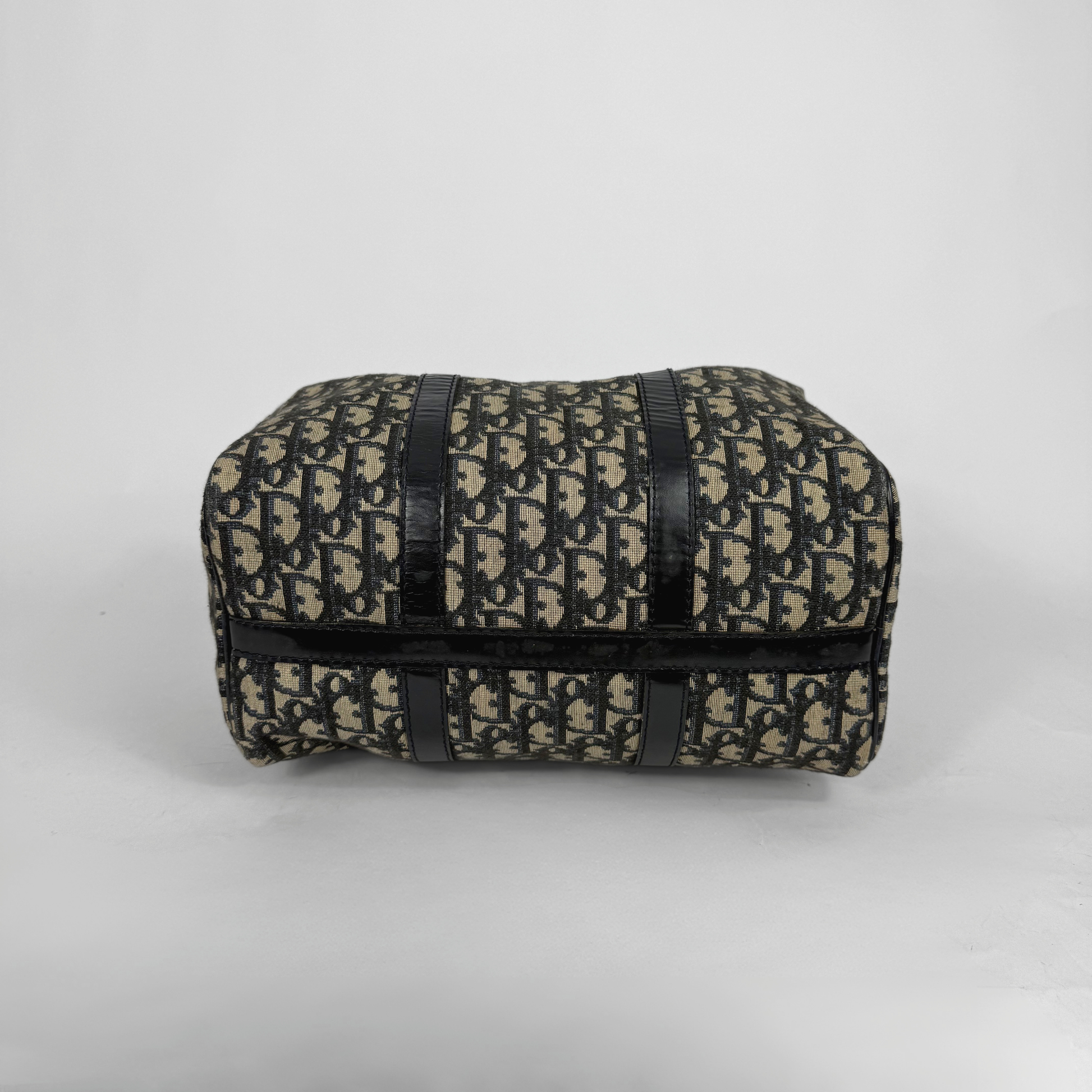 Patterned pouch with black straps on a light gray background