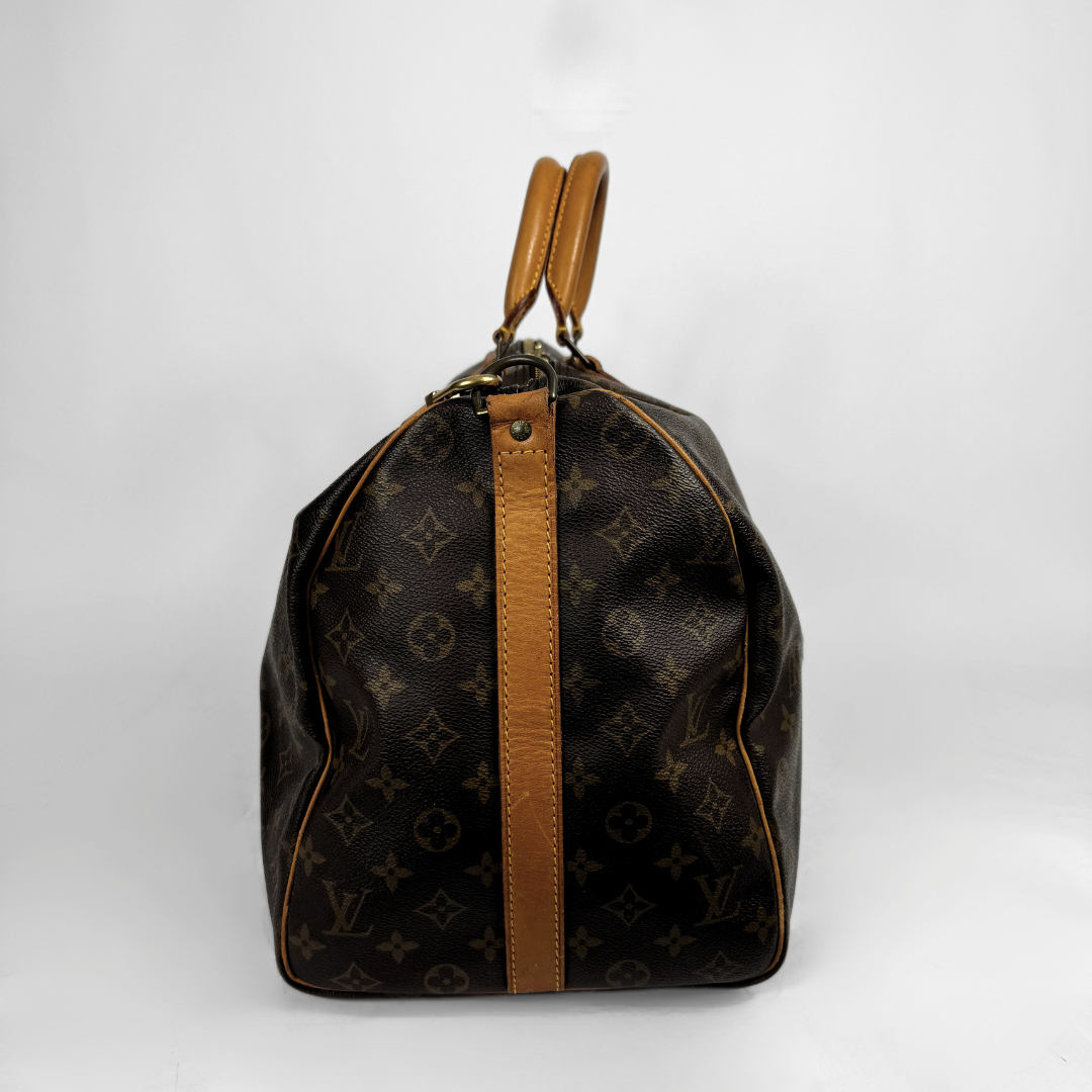 Louis Vuitton Keepall 50 with strap on a white background 