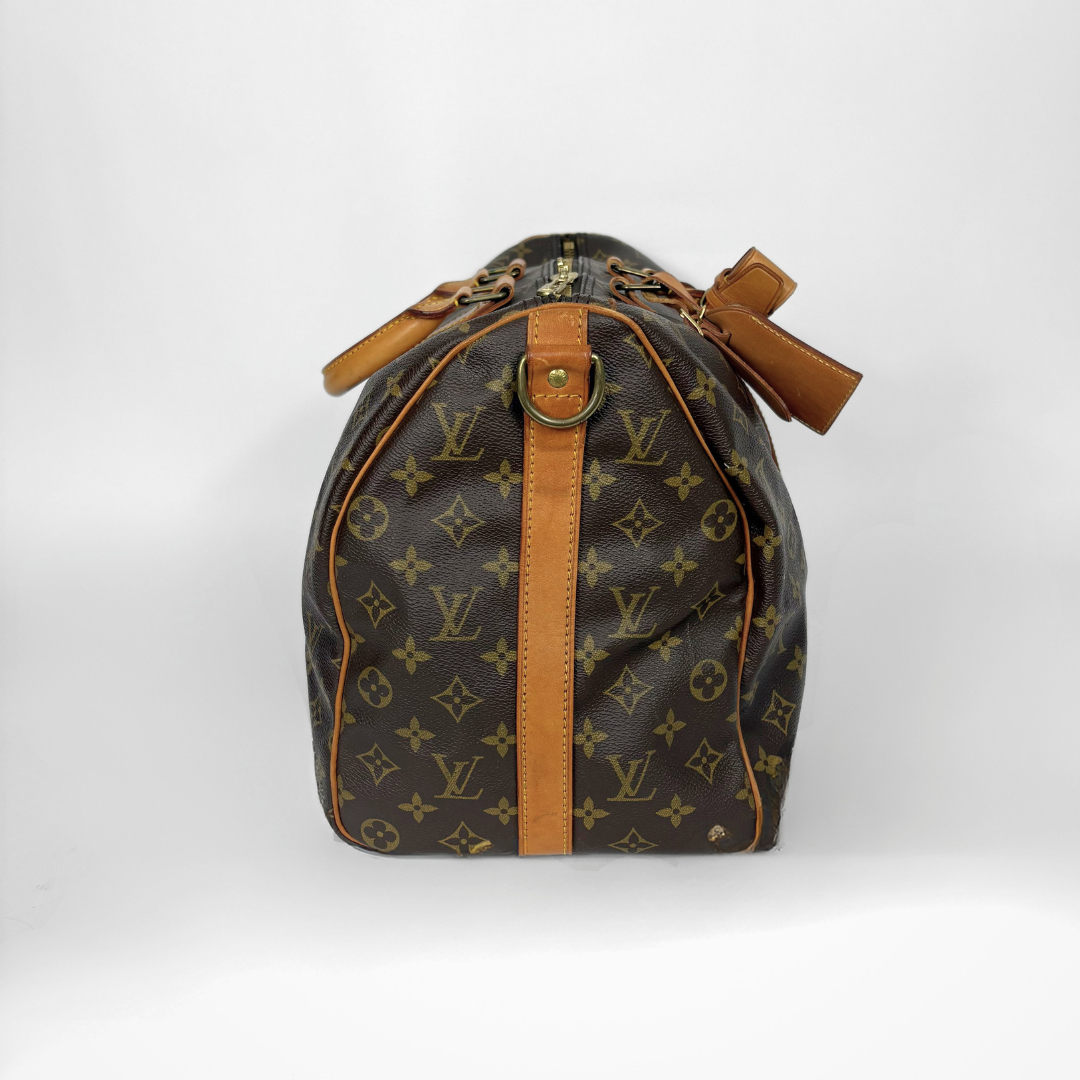 Designer handbag with monogram pattern on a white background