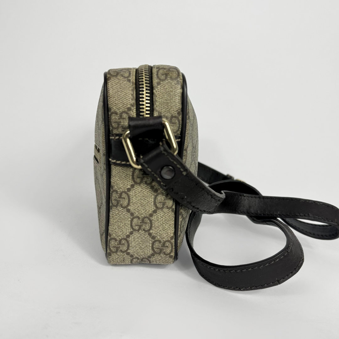 Gucci handbag with monogram pattern on a light gray background