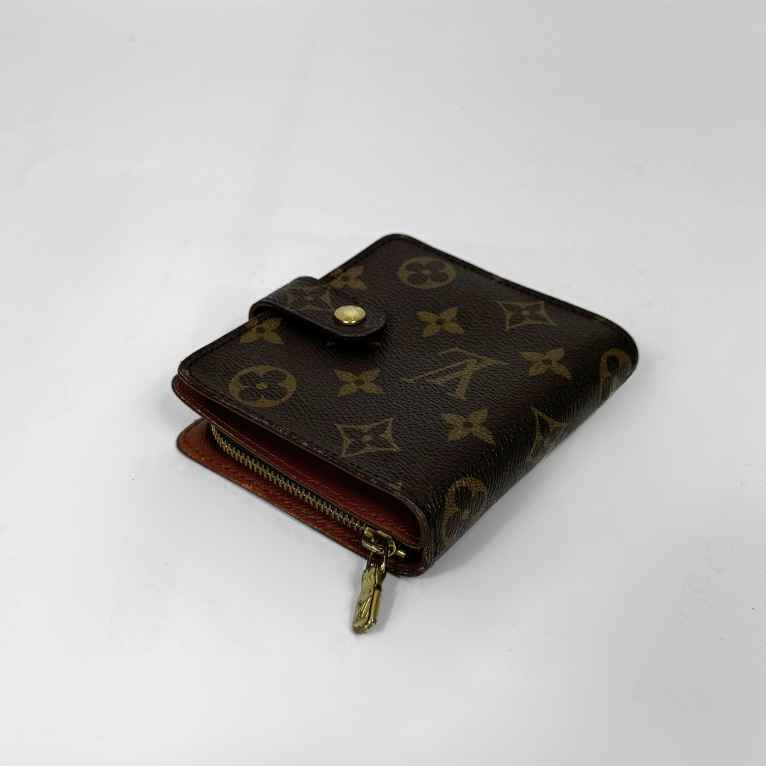 Louis Vuitton wallet with monogram pattern on a white background