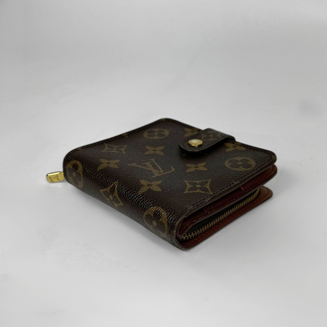 Brown wallet with monogram pattern on a light gray background