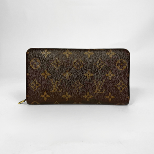 Louis Vuitton wallet with monogram pattern on a white background