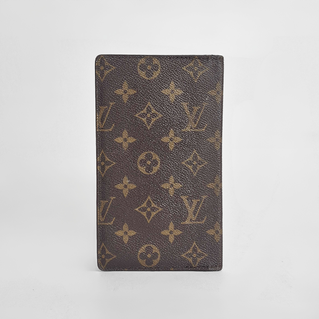 Louis Vuitton wallet with monogram pattern on a white background