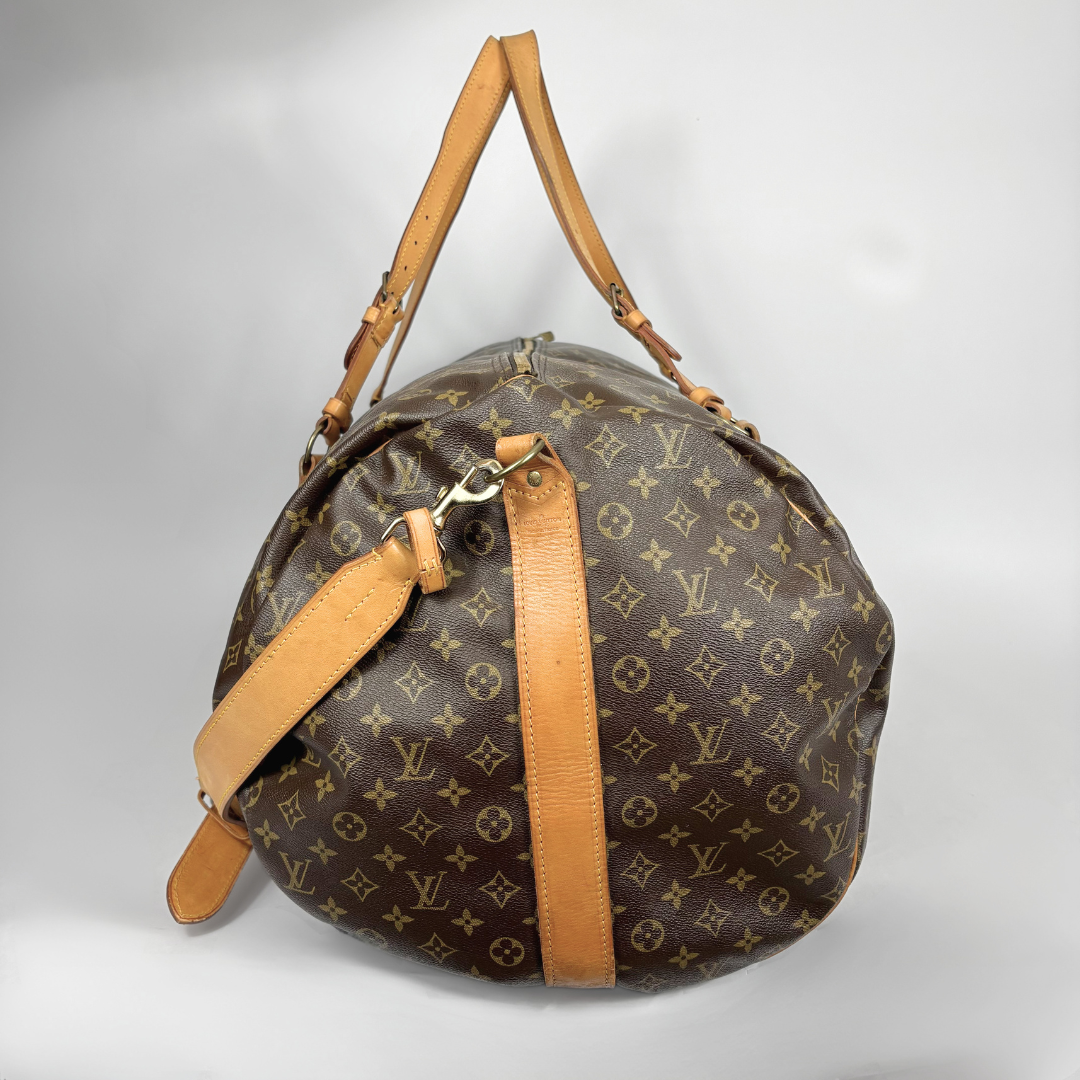 Louis Vuitton duffel bag with monogram pattern on a light gray background