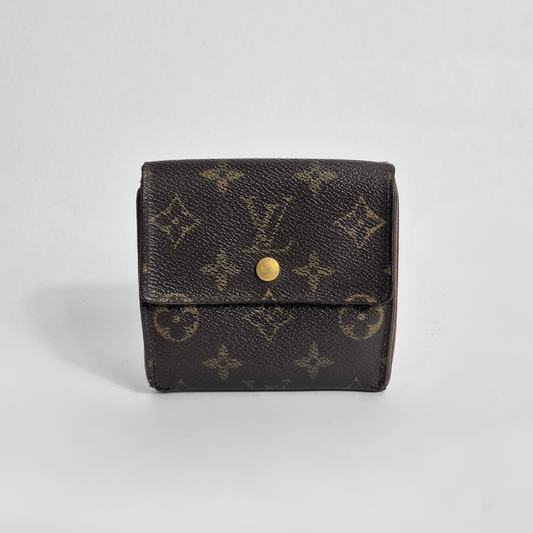 Louis Vuitton wallet with monogram pattern on a light gray background
