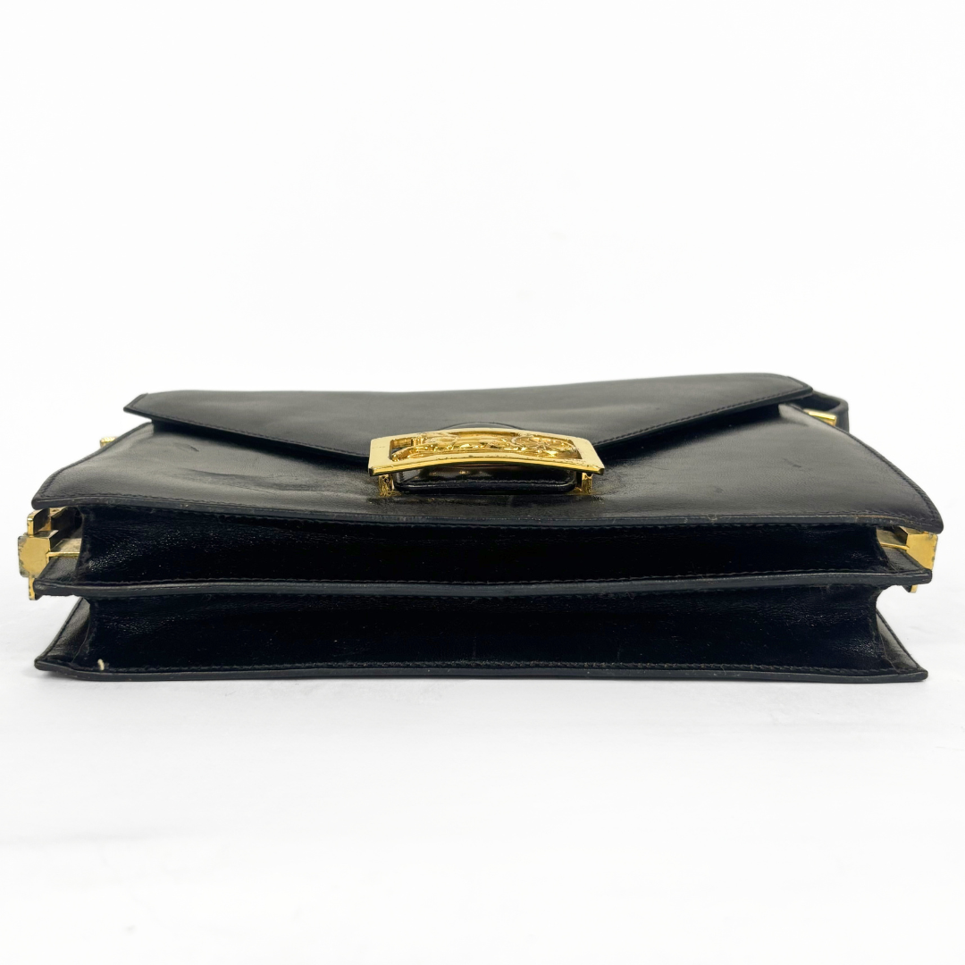 Celine vintage black leather shoulder bag with gold-tone horse and cariage buckle.